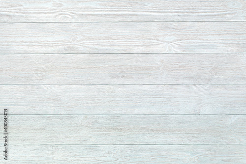 A universal background of textured boards  painted blue white. Ready light background for flat lay and other design ideas. Pale blue plank floor or wall in retro style. Copy space.