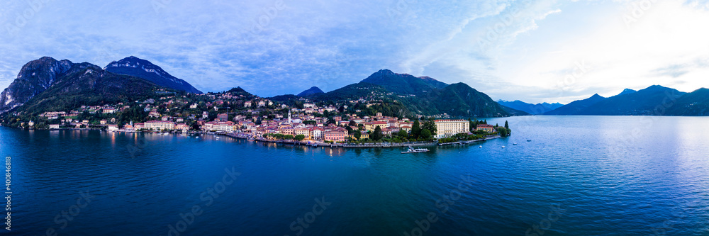 Italy, Province of Como, Menaggio, Helicopter panorama of Lake Como and coastal town at dawn Italy, Province of Como, Menaggio, Helicopter panorama of Lake Como and coastal town at dawn