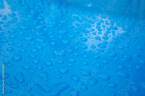 Close up Water droplets on blue background.