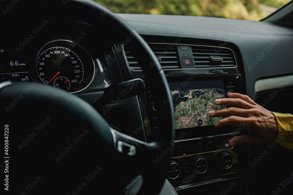 Hand of woman checking digital maps in car during vacations