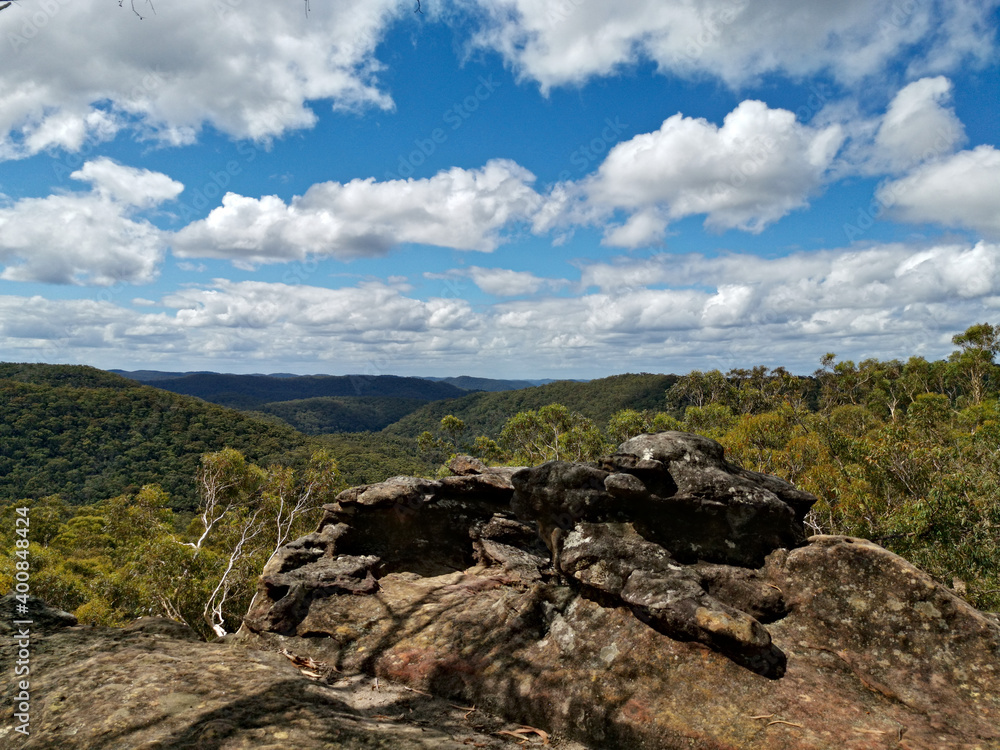 Breathtaking view of mountain and valley landscape on a blue sky with white clouds , Wideview Lookout, Berowra Heights, Berowra Valley National Park, Sydney, New South Wales, Australia
