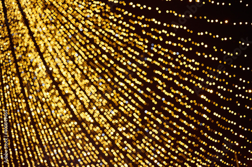 Many defocused christmas lights golden color texture.