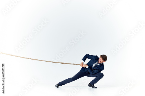 man with rope in hand on light background business finance advertising model