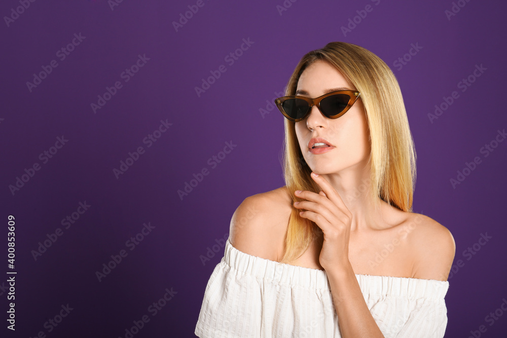Beautiful woman in stylish sunglasses on purple background. Space for text Beautiful woman in stylish sunglasses on purple background. Space for text