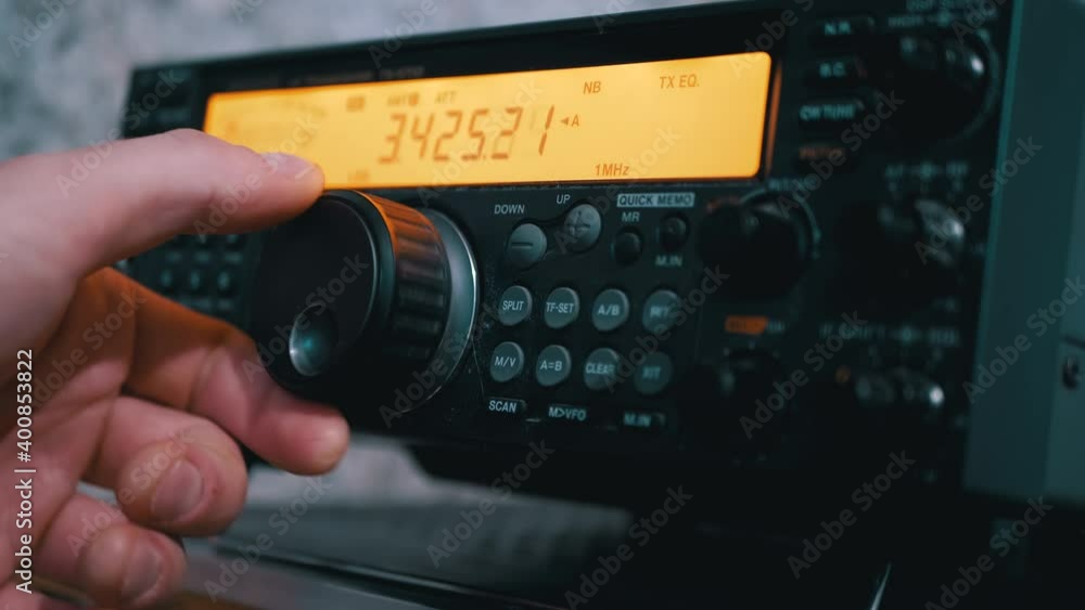 Male Hand Tunes Radio Communication Transceiver at Stationary Radio Station Male Hand Tunes Radio Communication Transceiver at Stationary Radio Station