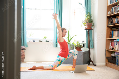 Sportswoman doing hand raised exercise at home