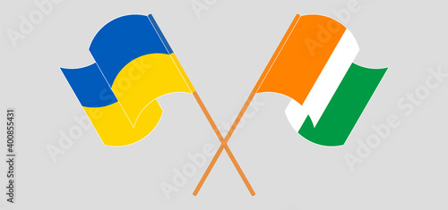 Crossed and waving flags of Ukraine and Republic of Ivory Coast