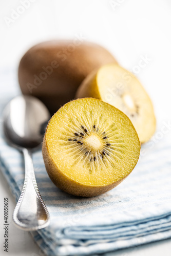 Halved ripe yellow kiwi fruit.
