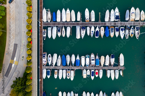 Switzerland, Canton of Ticino, Locarno, Helicopter view of boats moored in harbor of lakeshore town photo