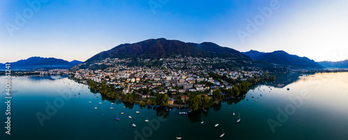 Switzerland, Canton of Ticino, Locarno, Helicopter view of town on shore of Lake Maggiore at dawn