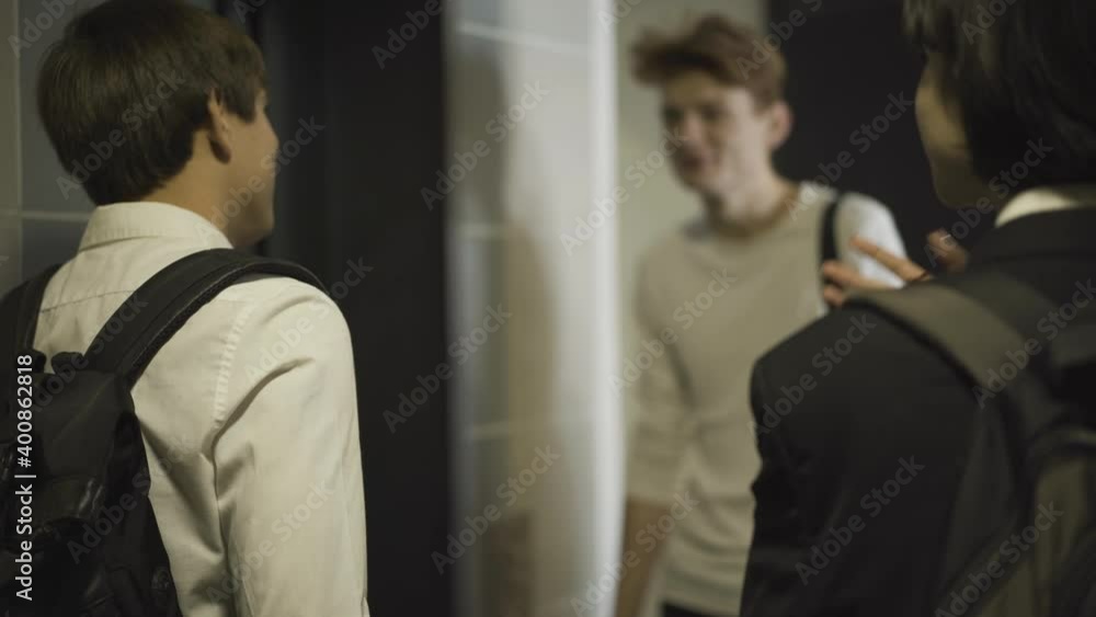 Group of high school classmates entering elevator lift. Positive friendly Caucasian teenage boys and girls in public school. Education and friendship concept. Group of high school classmates entering elevator lift. Positive friendly Caucasian teenage boys and girls in public school. Education and friendship concept.