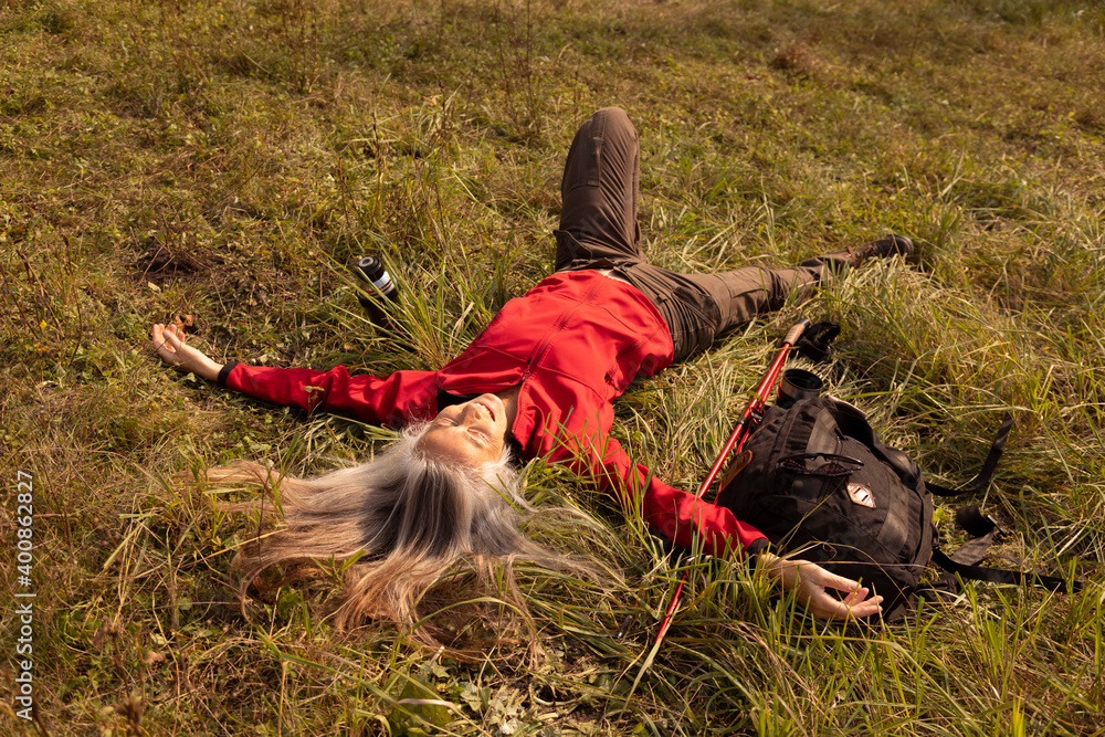 Carefree woman resting while lying on mountain at Alpine Foothills, Germany Carefree woman resting while lying on mountain at Alpine Foothills, Germany