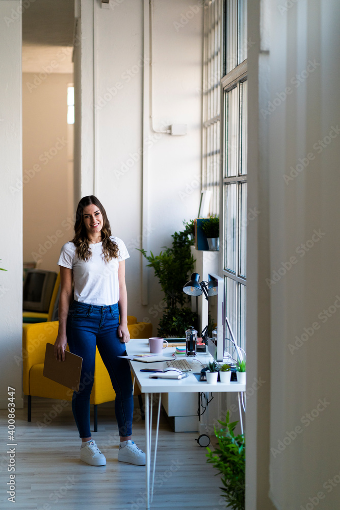 Smiling businesswoman standing in office Smiling businesswoman standing in office