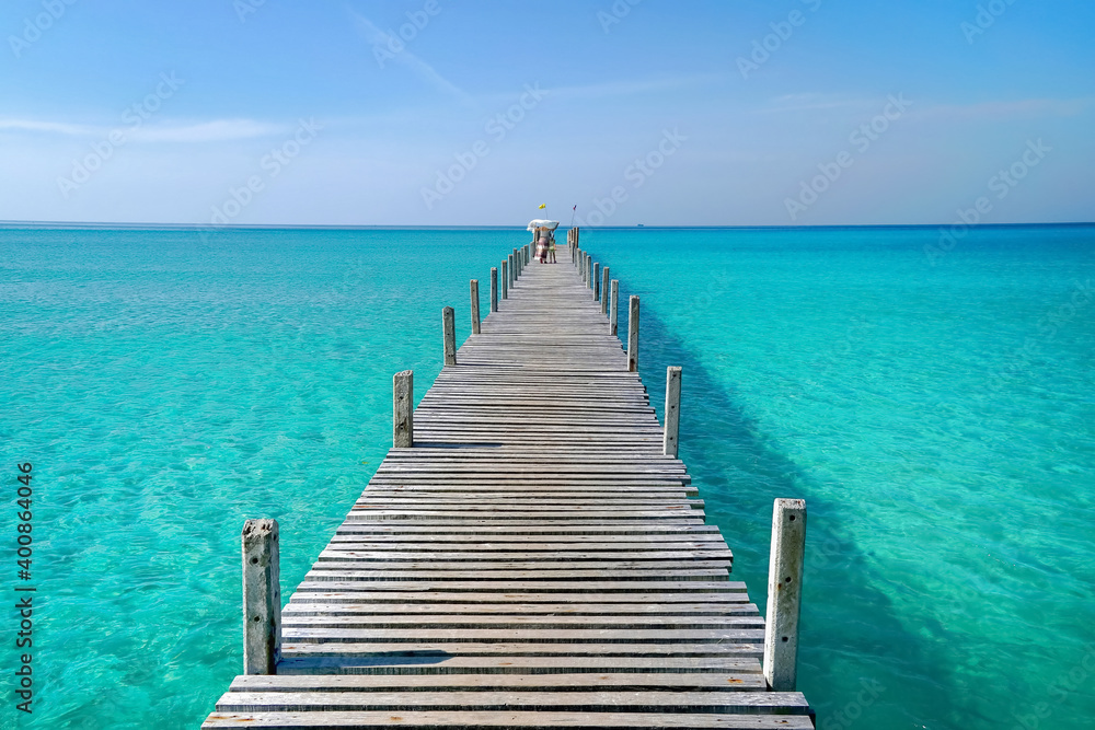 Mother and daughter are walking on a wooden bridge. Summer sea travel. Family relaxing at sea travel.