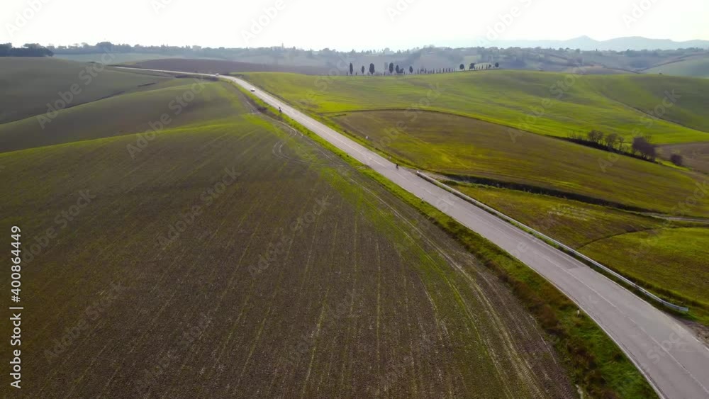 aerial drone view of a cyclist on a country road. Tuscany hills, Italy. daylight in winter aerial drone view of a cyclist on a country road. Tuscany hills, Italy. daylight in winter