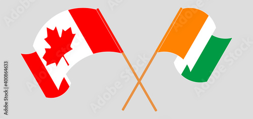 Crossed and waving flags of Canada and Republic of Ivory Coast