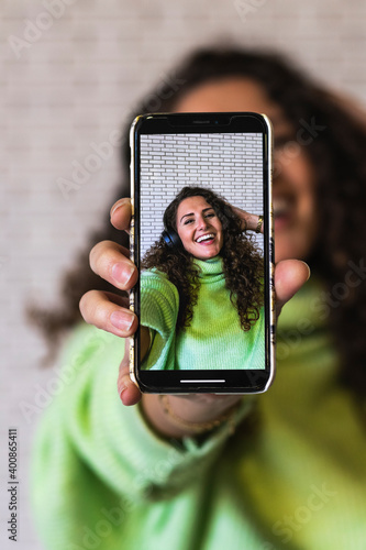 Young woman showing photograph on smart phone photo