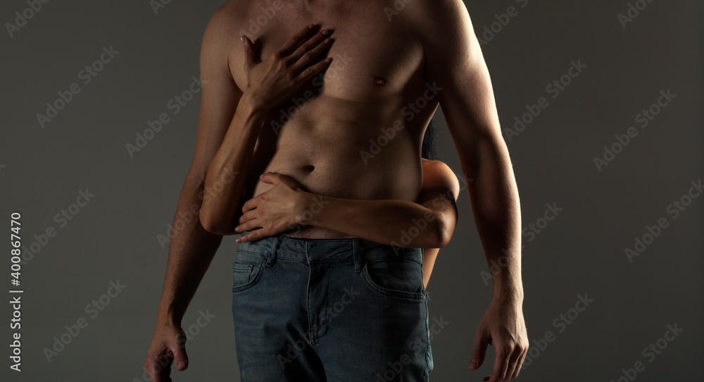Naklejka premium Muscular naked man and female hands. Sensual. Strong body. 
