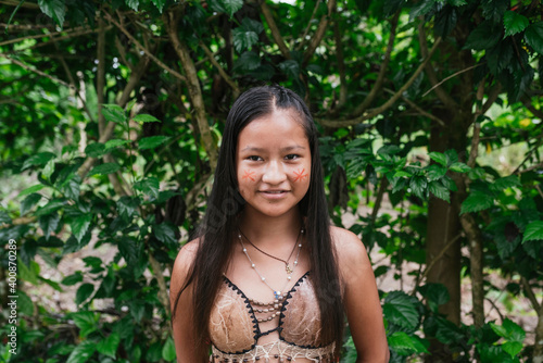 Smiling Guarani girl against tree at Misahualli, Ecuador