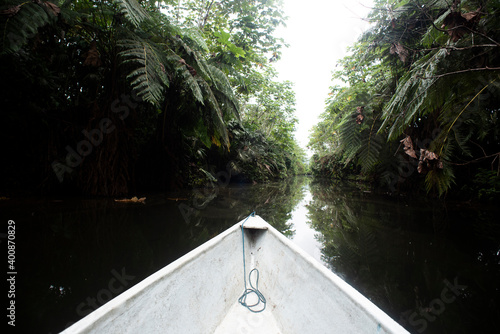 White ship's bow on Napo River amidst trees, Ecuador photo