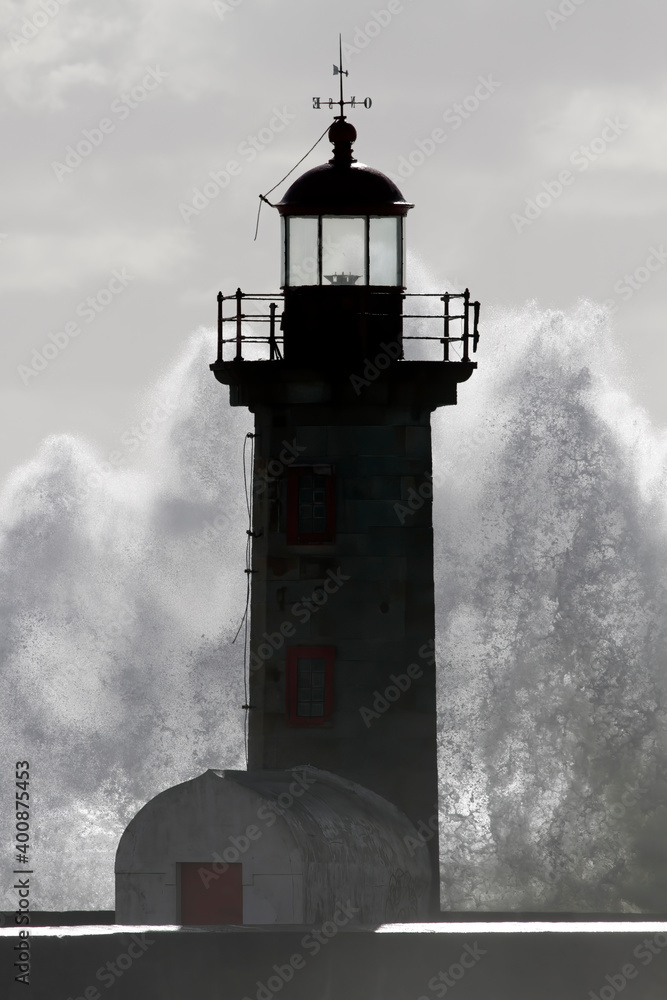 Backlit lighthouse during storm