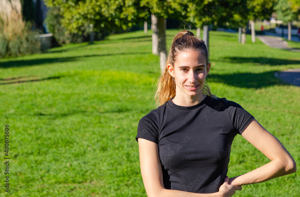 Young Blonde Girl in Black Tracksuit Posing at Park Ready for Yoga Class Young Blonde Girl in Black Tracksuit Posing at Park Ready for Yoga Class