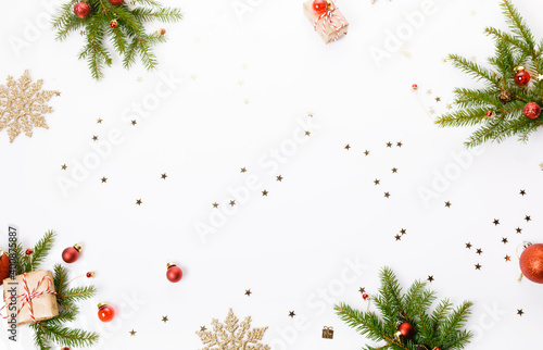 Christmas or New Year background, composition made of red Xmas decorations, gifts and fir branches on white background, flat lay