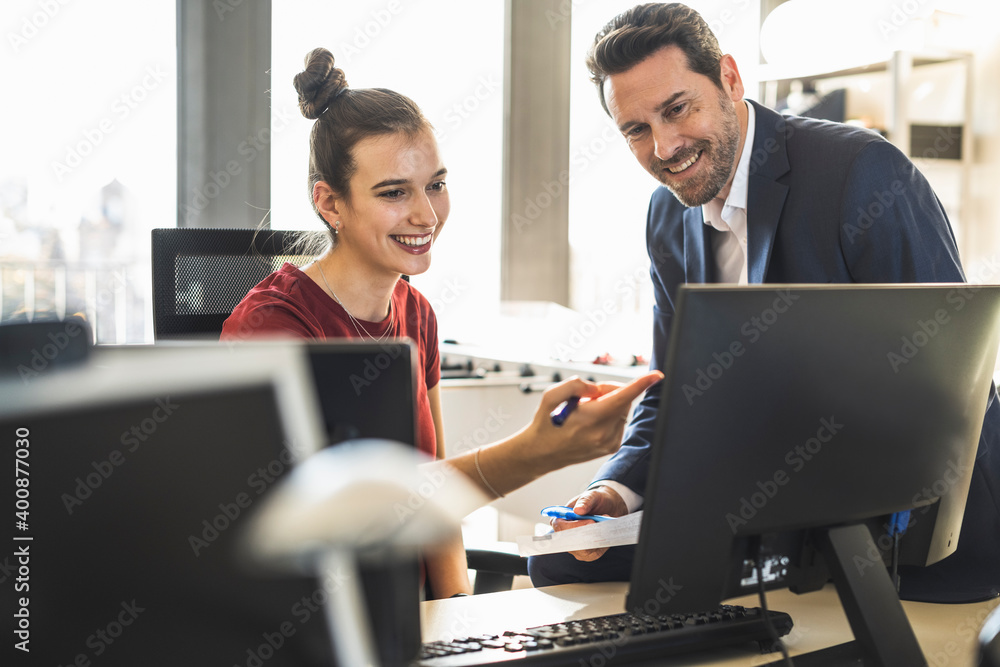 Team working together while sitting at office