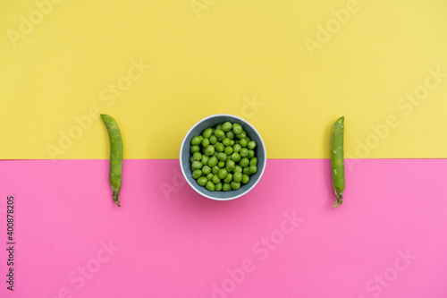 Studio shot of two green pea pods and bowl of green peas photo