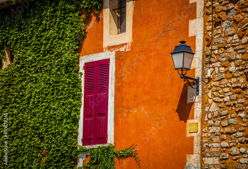 Colourful windows and houses in the ancient village of Roussilion in Provence, France photo