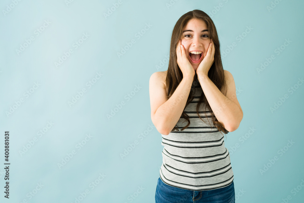 Smiling caucasian woman is looking shocked and happy Smiling caucasian woman is looking shocked and happy