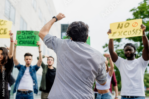 Protestors with banners protesting on street in city photo