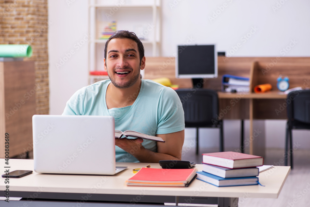 Young male student preparing for exams at home in tele-education Young male student preparing for exams at home in tele-education