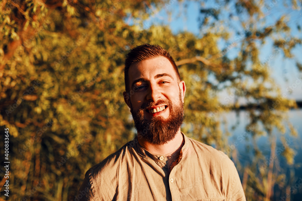 Portrait of smiling man at a lake at sunset Portrait of smiling man at a lake at sunset