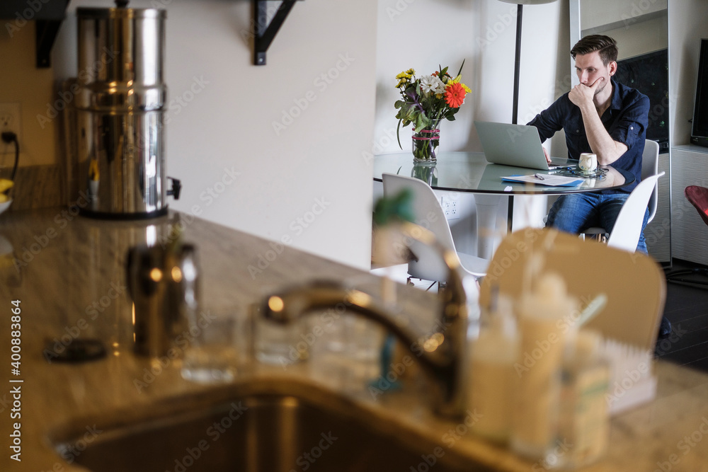 Man working on laptop at home Man working on laptop at home
