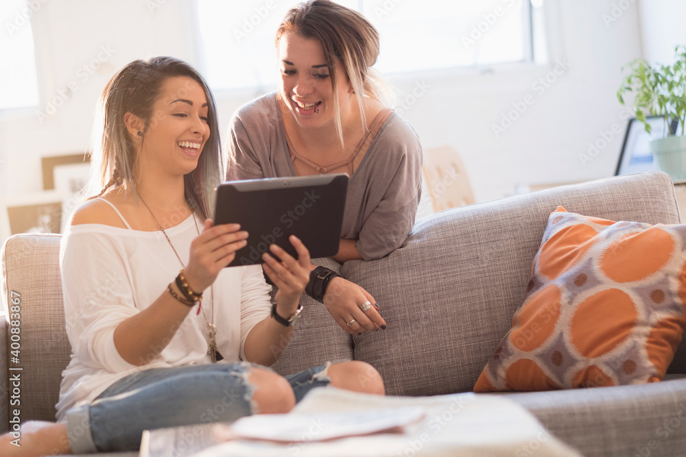 Young women using digital table at home Young women using digital table at home