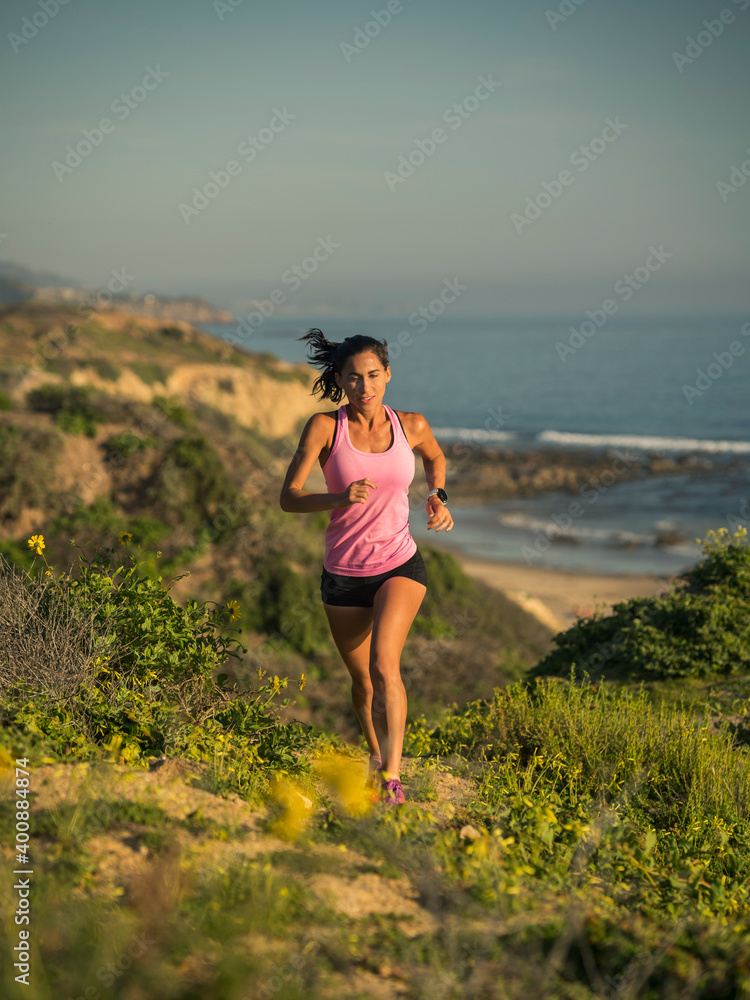 USA, California, Newport Beach, Woman running along cliff USA, California, Newport Beach, Woman running along cliff