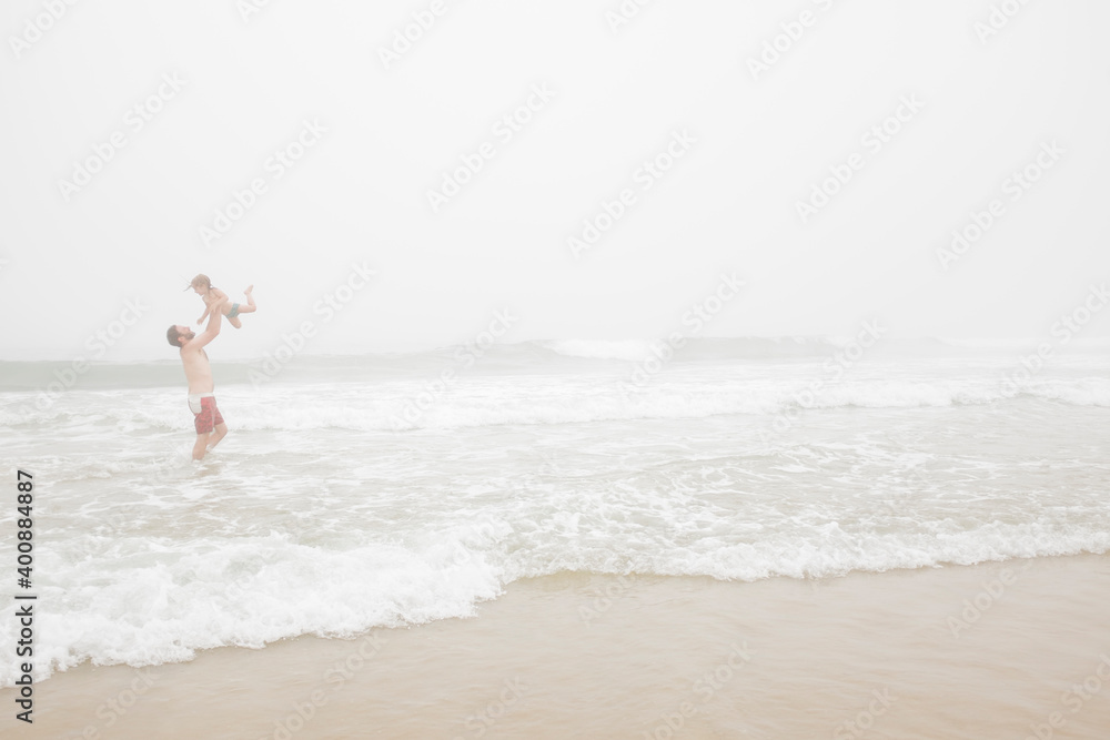 USA, New York, Monatuk, Father and daughter (2-3) on beach by ocean USA, New York, Monatuk, Father and daughter (2-3) on beach by ocean