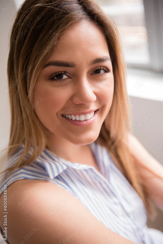 Portrait of young woman looking at camera and smiling Portrait of young woman looking at camera and smiling