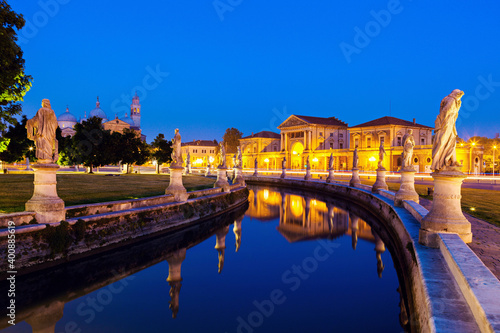 Illuminated Prato della Valle with statues at dusk