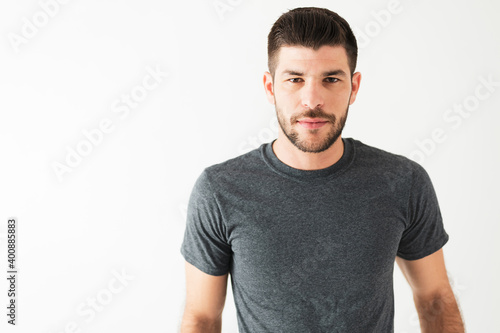 Portrait shot of a good-looking latin man in front of a white background