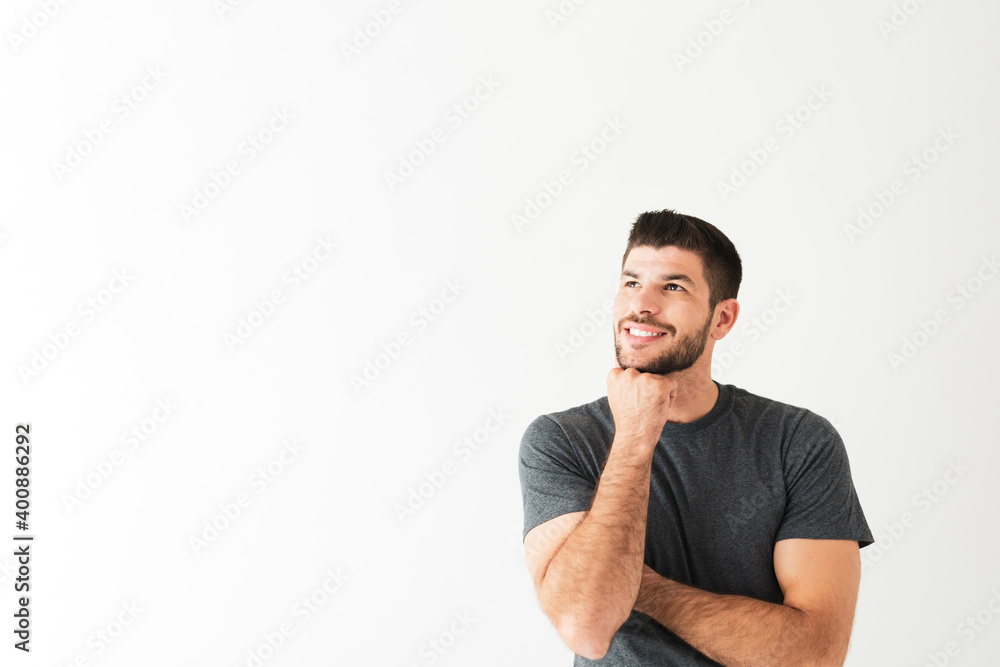 Positive young man is thinking and remembering good times Positive young man is thinking and remembering good times