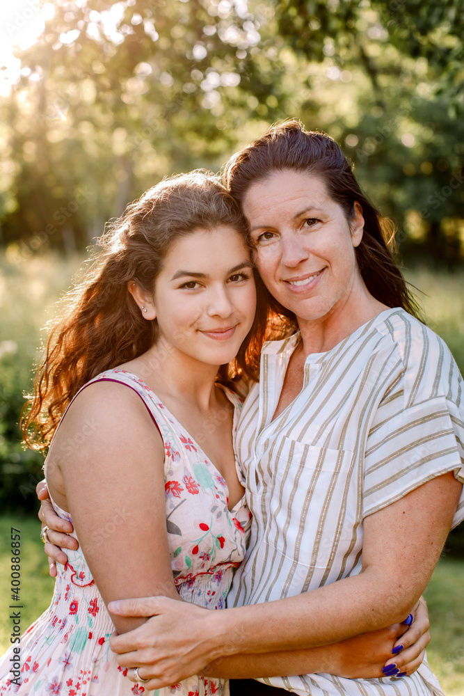 Portrait of smiling mother and daughter in yard Portrait of smiling mother and daughter in yard