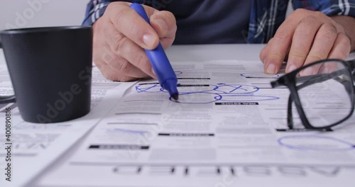 man looking for a new job in newspaper classified