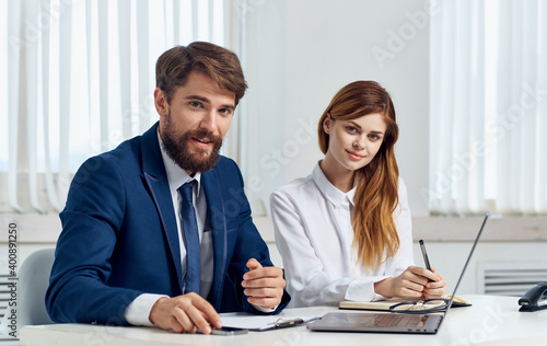 Business man and woman in shirt with laptop at the table in the office staff office © SHOTPRIME STUDIO