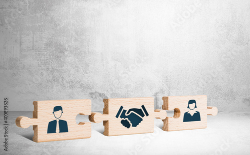 Wooden puzzle with icons of a man, mediator and woman. The concept of the role of a mediator in saving the family, mediation.