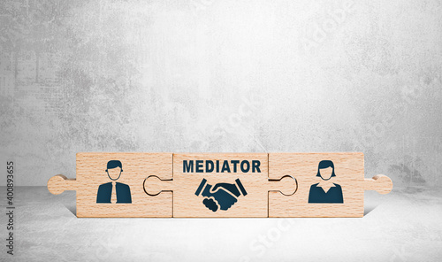 Wooden puzzle with icons of a man, mediator and woman. The concept of the role of a mediator in saving the family, mediation.