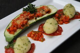Vegetarian stuffed zucchini served with parsley potatoes