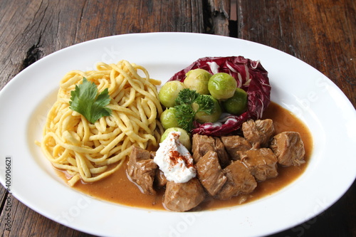 Veal goulash served with Brussels sprouts and spaetzle