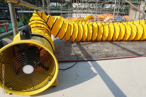 Flexible air duct for ventilation from confined spaces in the construction of large chemical storage tanks.